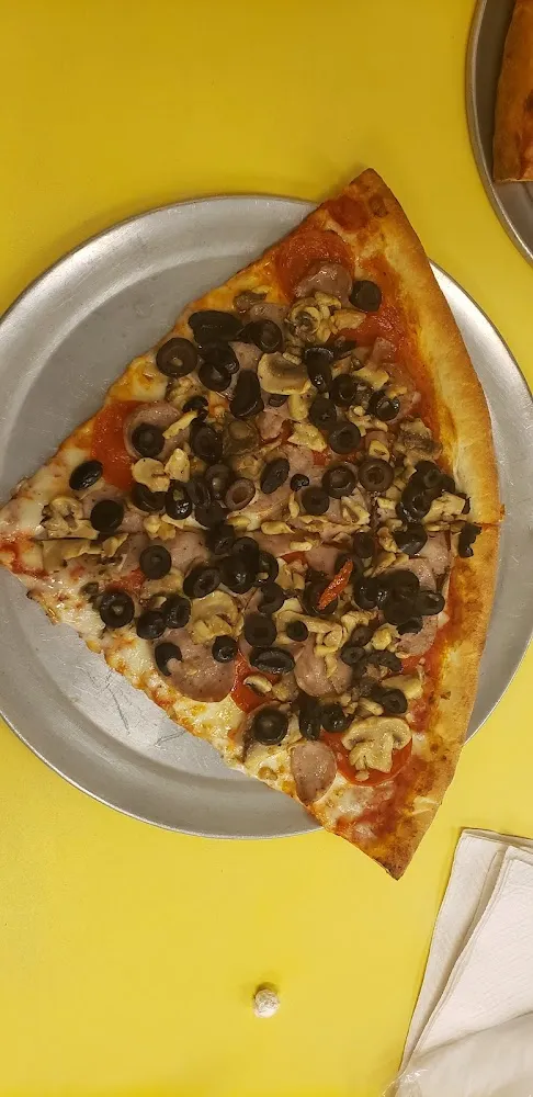 Pepperoni Sausage Mushrooms an Black Olives Pizza Slices